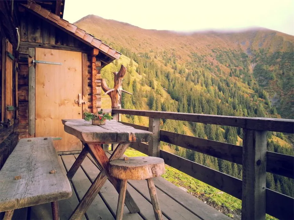 Timber deck with railing overlooking a forested valley